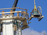 The bell being lowered from the steeple.