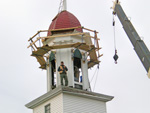 The bell being removed from the steeple.